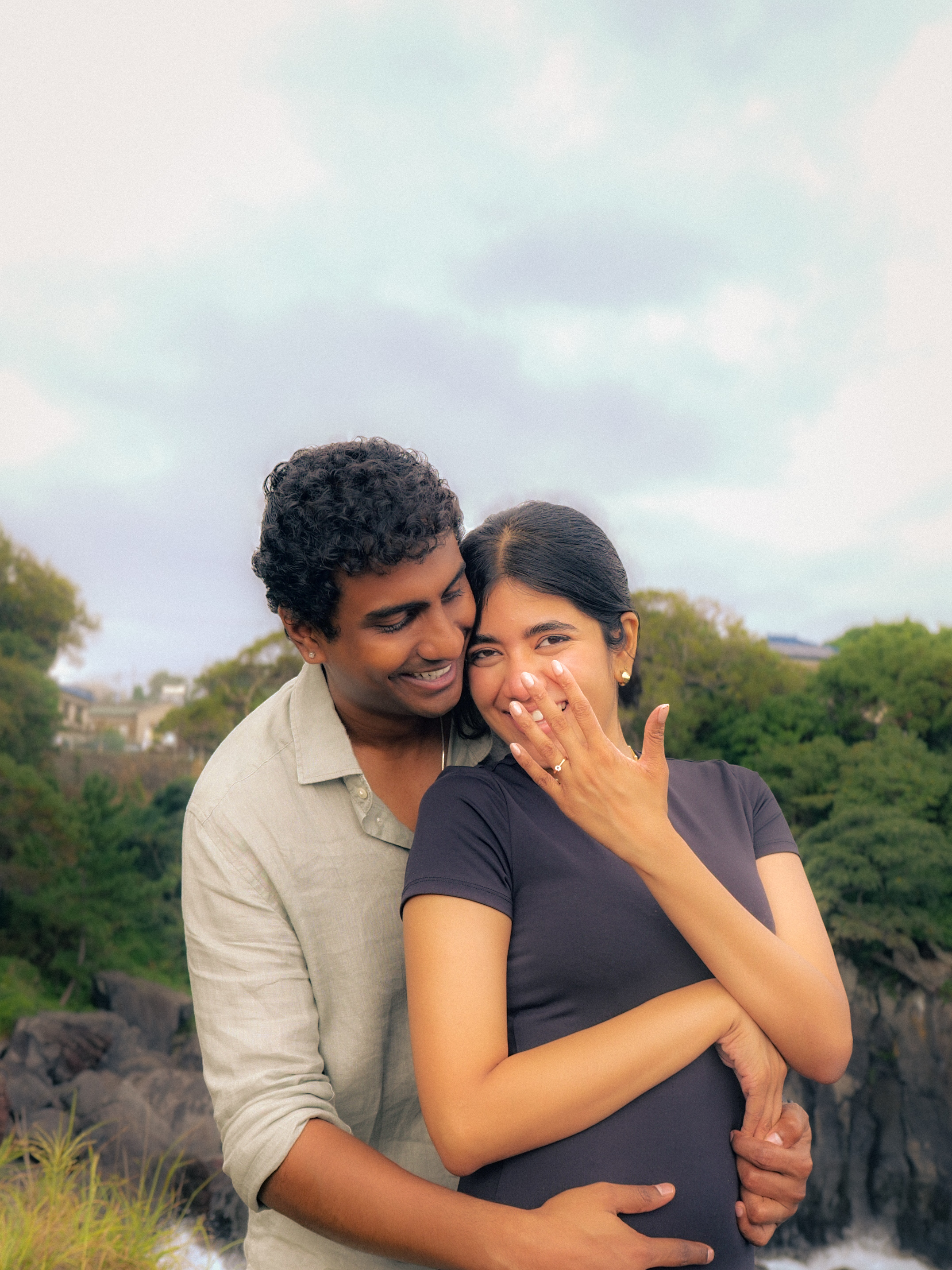 The couple embracing as the ring is shown to camera.